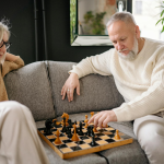 elderly couple playing chess